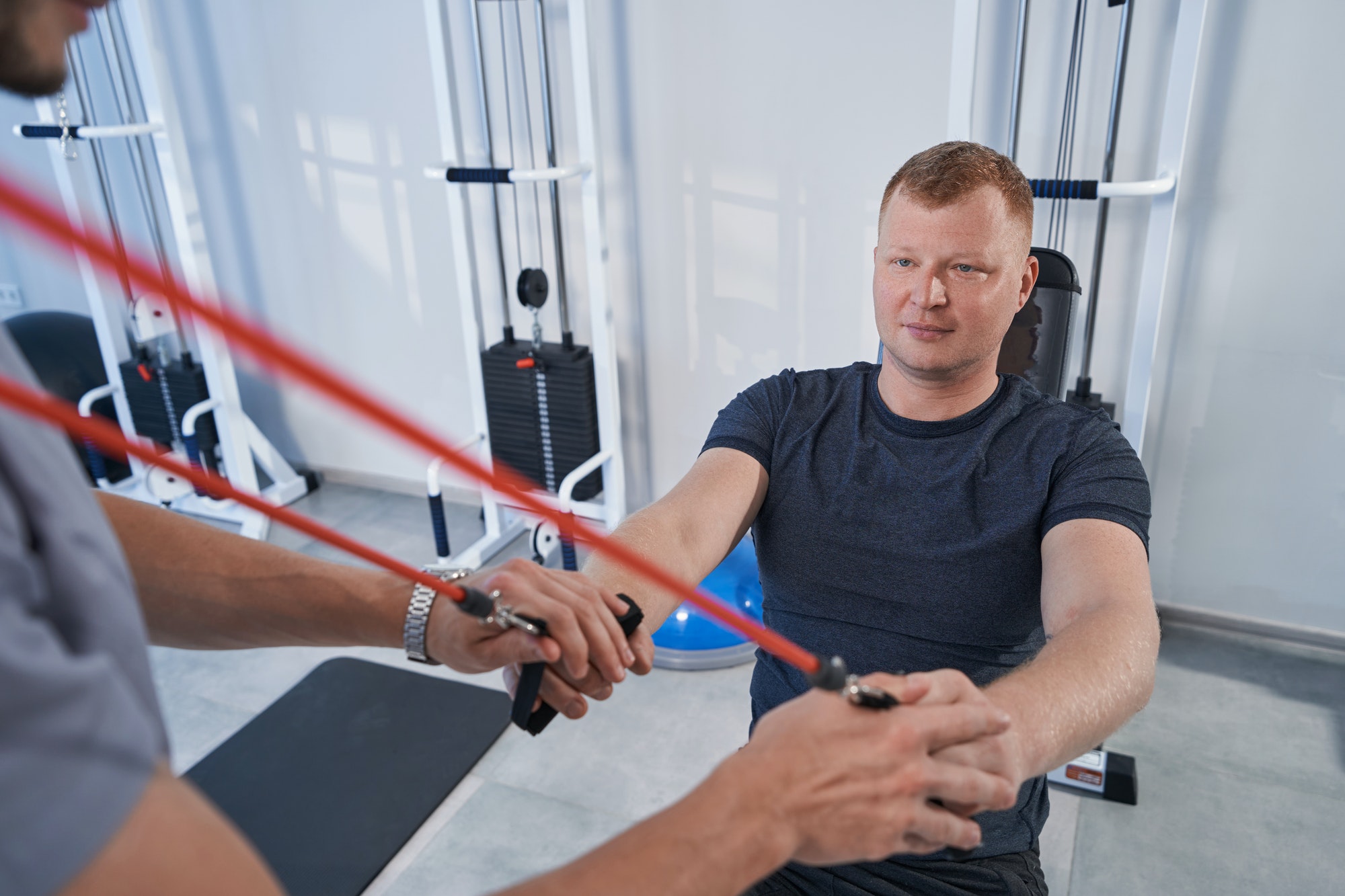 Close-up man on specialized decompression simulator at rehab clinic